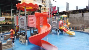 A water park with a red spiral slide, a pool, and various play structures. - 1Br Apartment For 2 Pax At Teluk Intan (Jakarta)