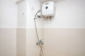 A bathroom with a wall-mounted shower unit, a handheld showerhead, and a control panel. - 1Br Apartment For 2 Pax At Teluk Intan (Jakarta)