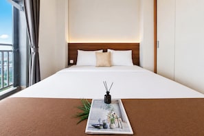 A hotel room with a large bed, a view of the city, and a magazine on the bed. - Smart Living Studio At Apartment Springwood Residence Tangerang (Tangerang)