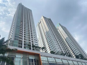 A high-rise building with multiple floors, large windows, and a modern architectural design. - Strategic And Cozy 1Br At Apartment Thamrin Residence (Jakarta)