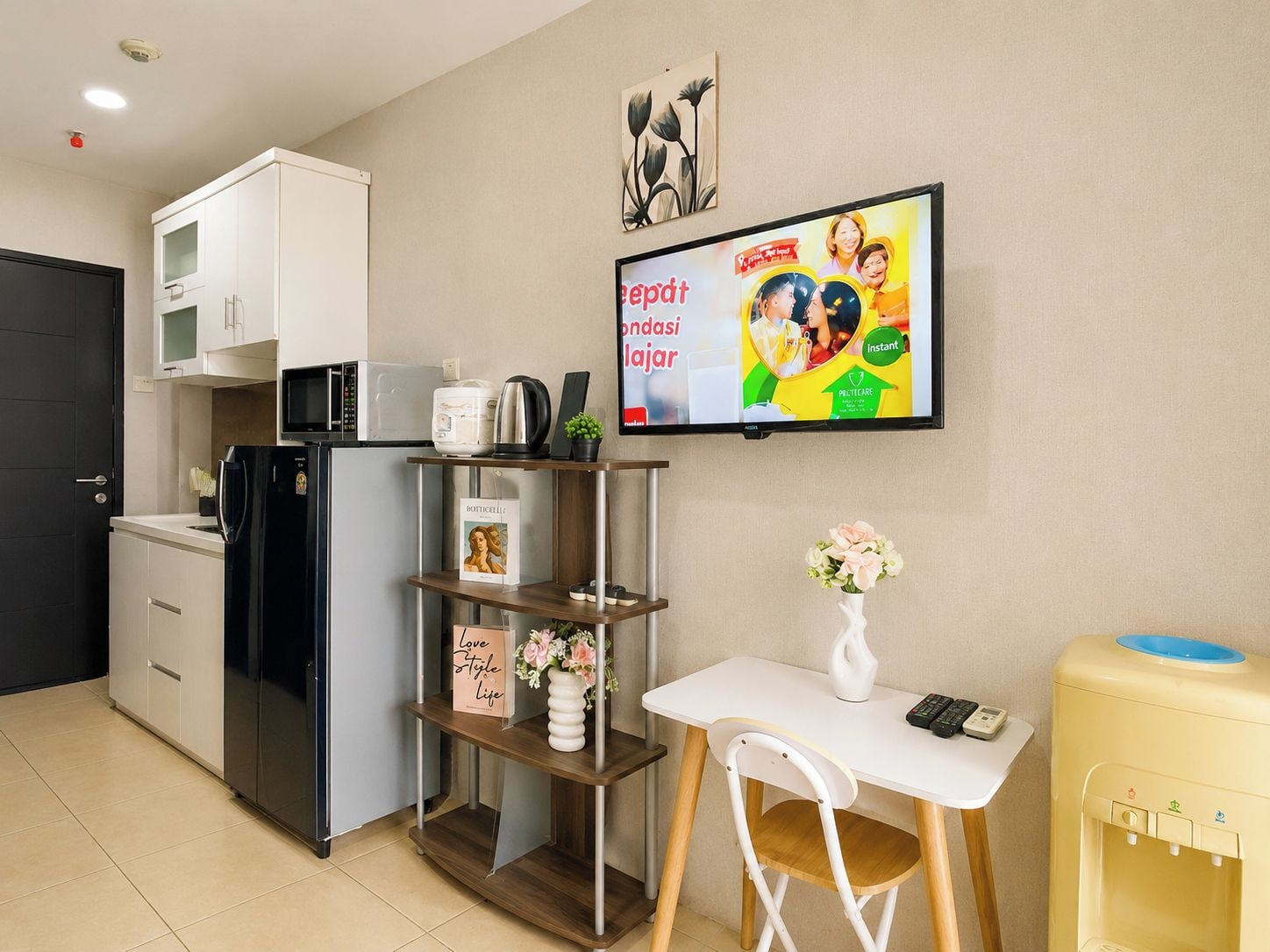 A compact kitchenette with a refrigerator, microwave, and coffee maker.