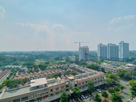 A residential area with multiple apartment buildings, a parking lot, and a construction crane in the distance.