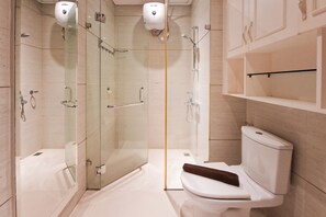 A modern bathroom with a glass-enclosed shower, a toilet, and a sink. - Affordable Neat 1Br At Apartment Brooklyn Alam Sutera (Tangerang)