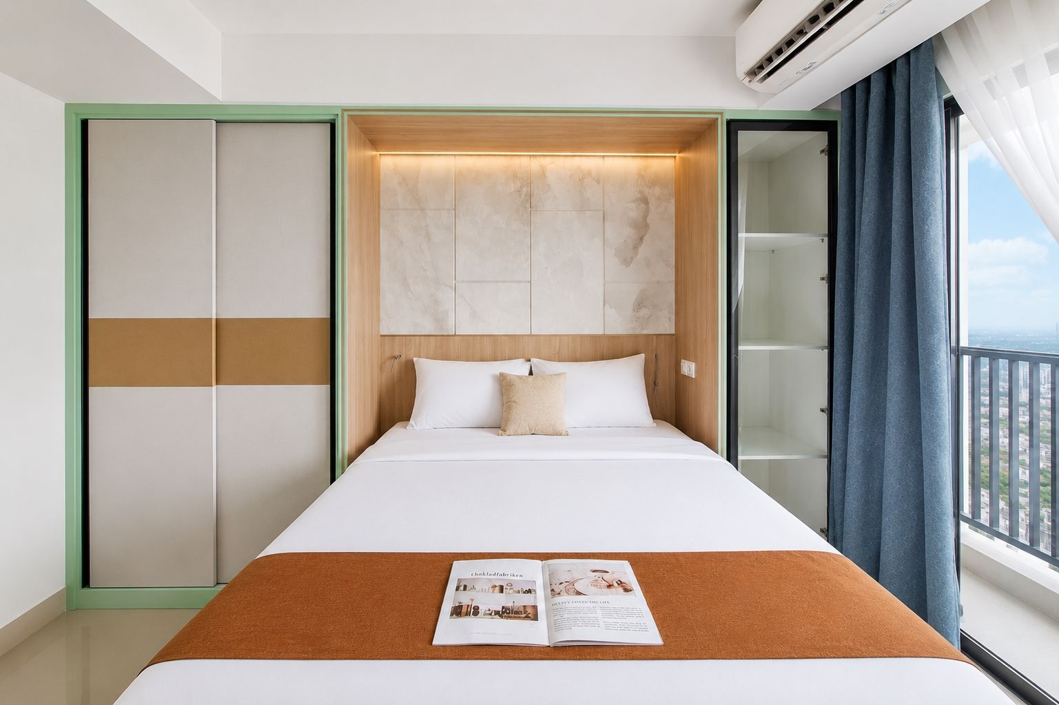 A hotel room with a bed, a magazine on the bed, a wardrobe, and a view through the window.