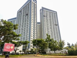 A high-rise building with multiple balconies and a sign indicating a show unit.