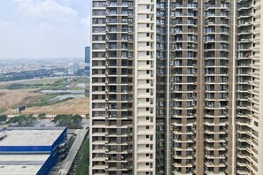 A high-rise building with multiple balconies and a view of a cityscape in the background. - Modern Look Studio At Apartment Sky House Alam Sutera (Tangerang)