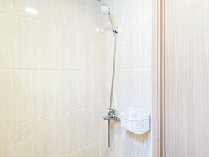 A shower with a handheld showerhead and a corner-mounted faucet. - Strategic Location Studio Room At Apartment Meikarta District 2 (Cikarang)