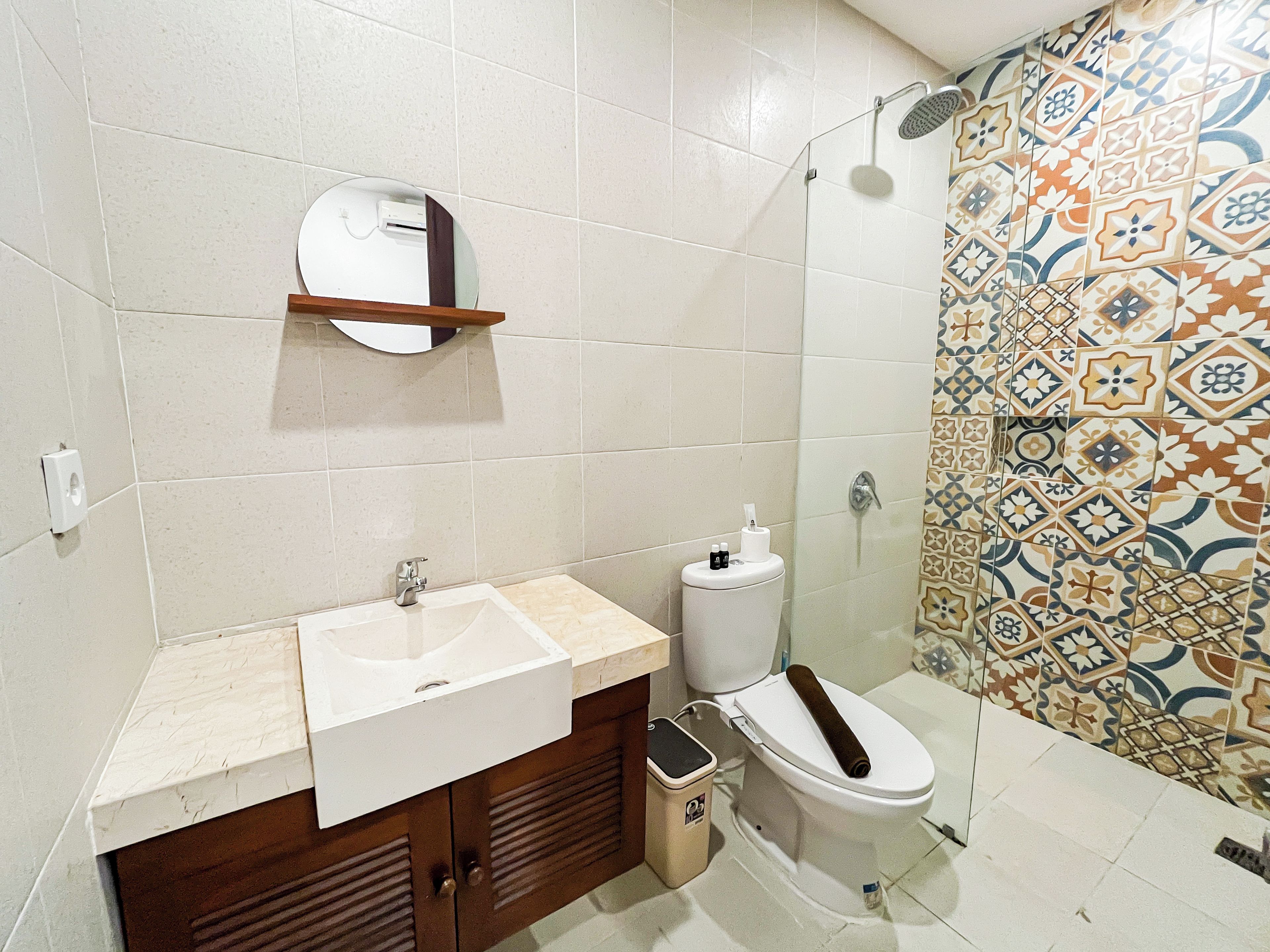 A bathroom with a sink, toilet, and shower.