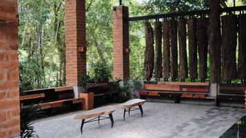 An outdoor seating area with benches and a brick column structure.