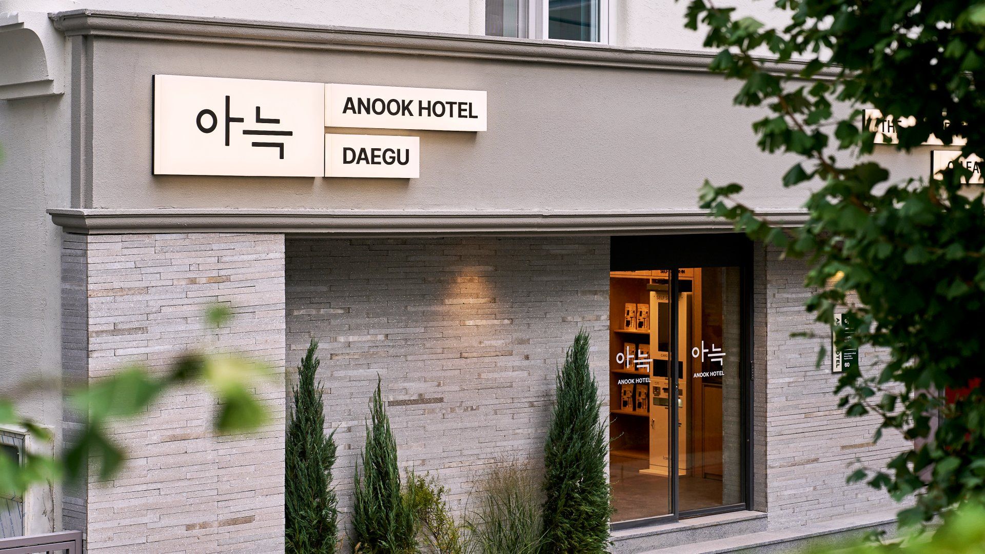 Exterior del hotel Anook en Daeju, con fachada de ladrillo y entrada de vidrio.