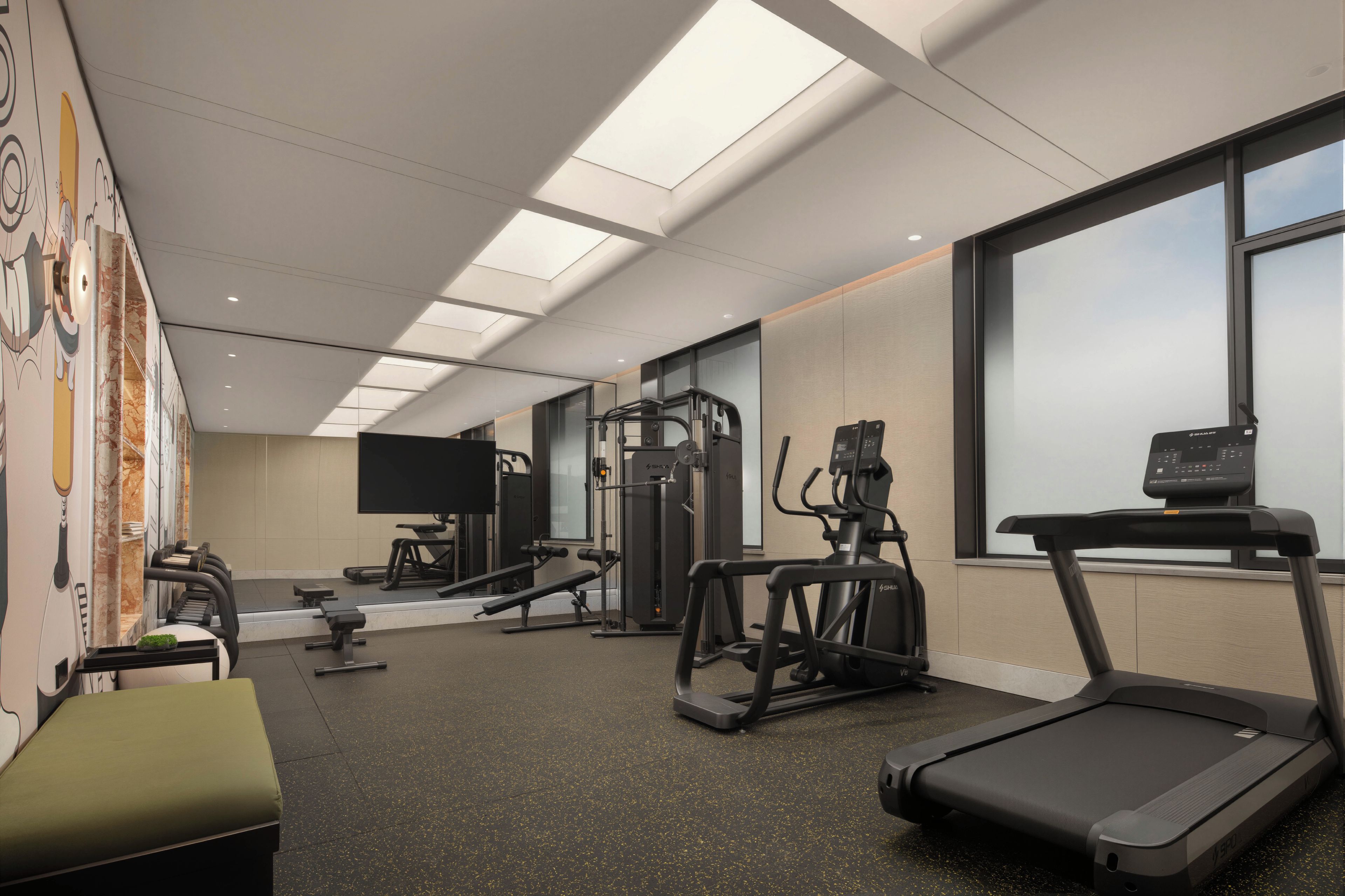 A gym with various exercise equipment, including treadmills and weight machines.