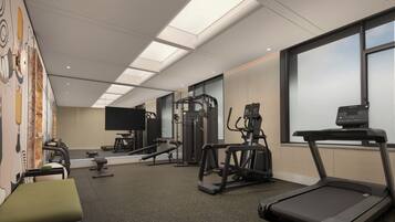 A gym with various exercise equipment, including treadmills and weight machines.