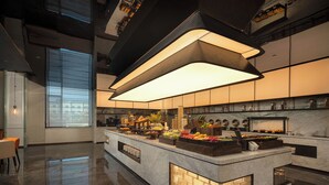 A modern kitchen with a central island, marble countertops, and a large overhead light fixture. - Wanda Yi Sayram Lake (Bole)