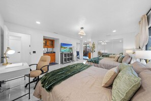 A hotel room with two beds, a desk, a chair, a TV, and a view of the outdoors. - Mountain View, 2500 sqft, King Bed, Garage, 3BR/2Bth (Jamul)