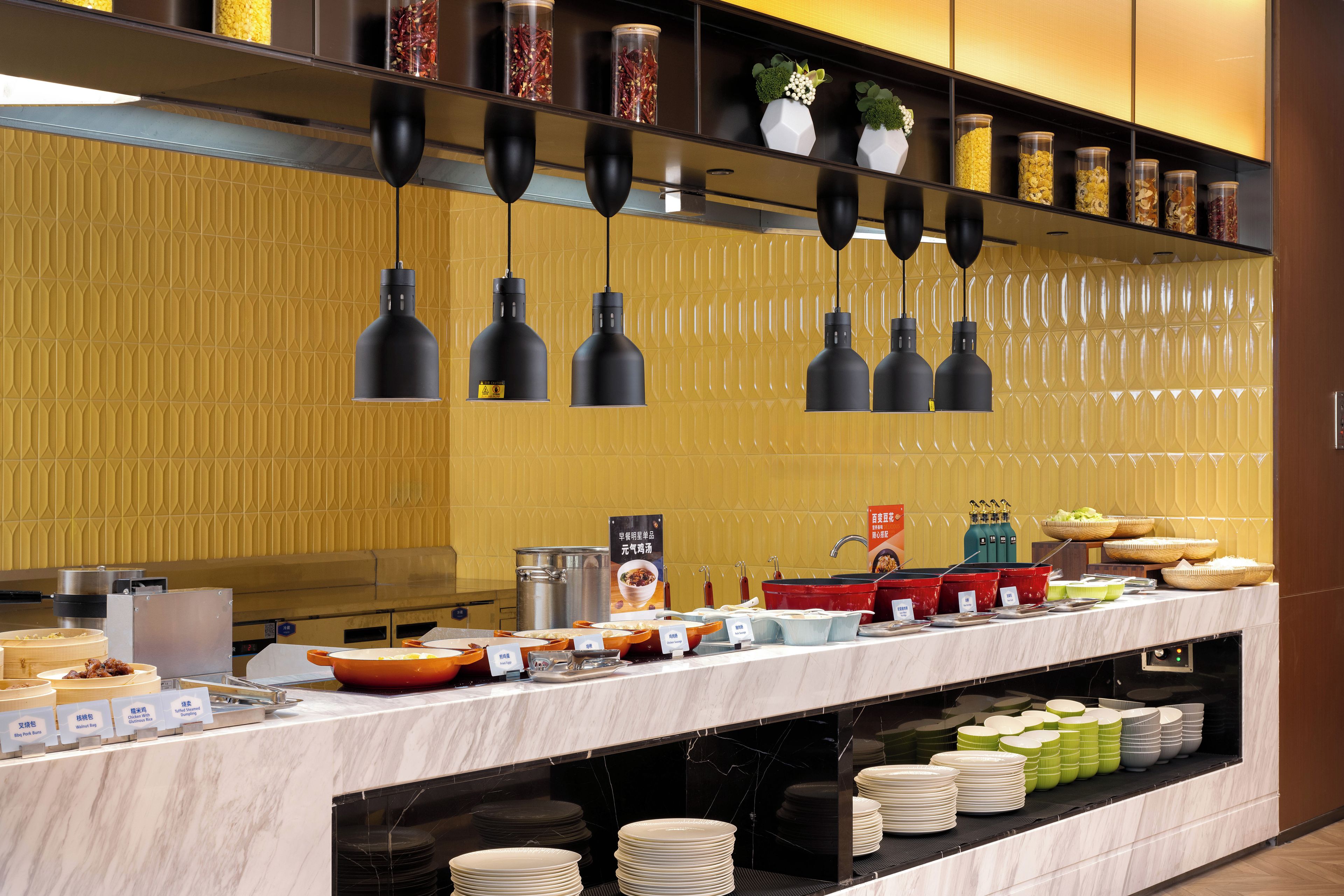 A buffet setup with various food items and utensils.