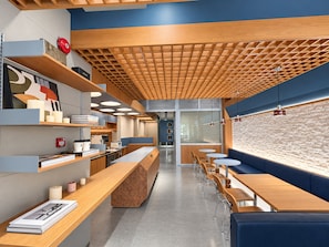 A modern interior with a long counter, seating area, and a patterned ceiling. - Aura Hotel Purvis L2 (Singapore)