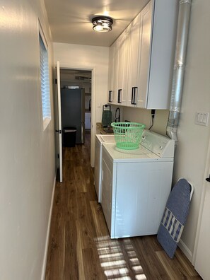 A compact laundry room with a washing machine, a dryer, and a utility sink. - 3-Bedroom Ponderosa Paradise at 6,398 feet. Beautifuly cool. (Prescott)