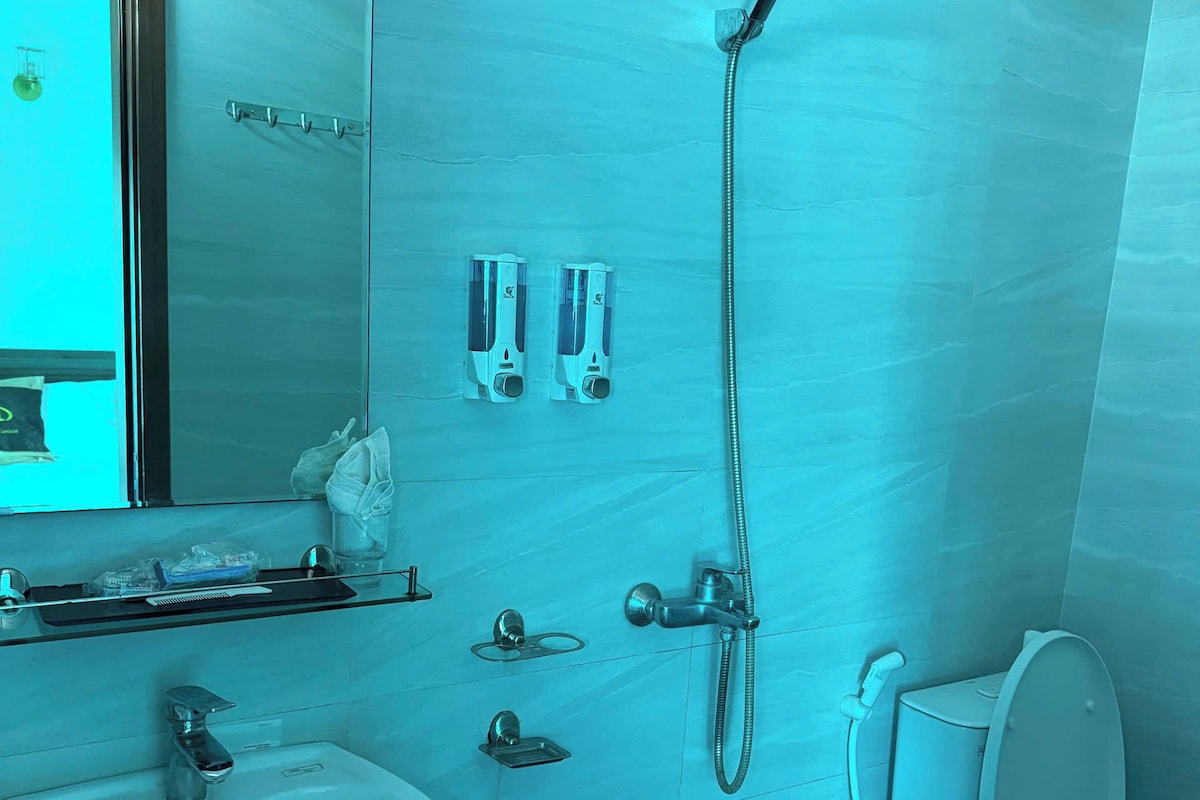 A modern bathroom with a sink, toilet, and shower.