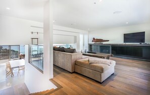 A modern living room with a sectional sofa, a fireplace, and a large TV. - Dromana Relaxation Escape by Ready Set Stay- Positioned on a cliff & WiFi (Dromana)