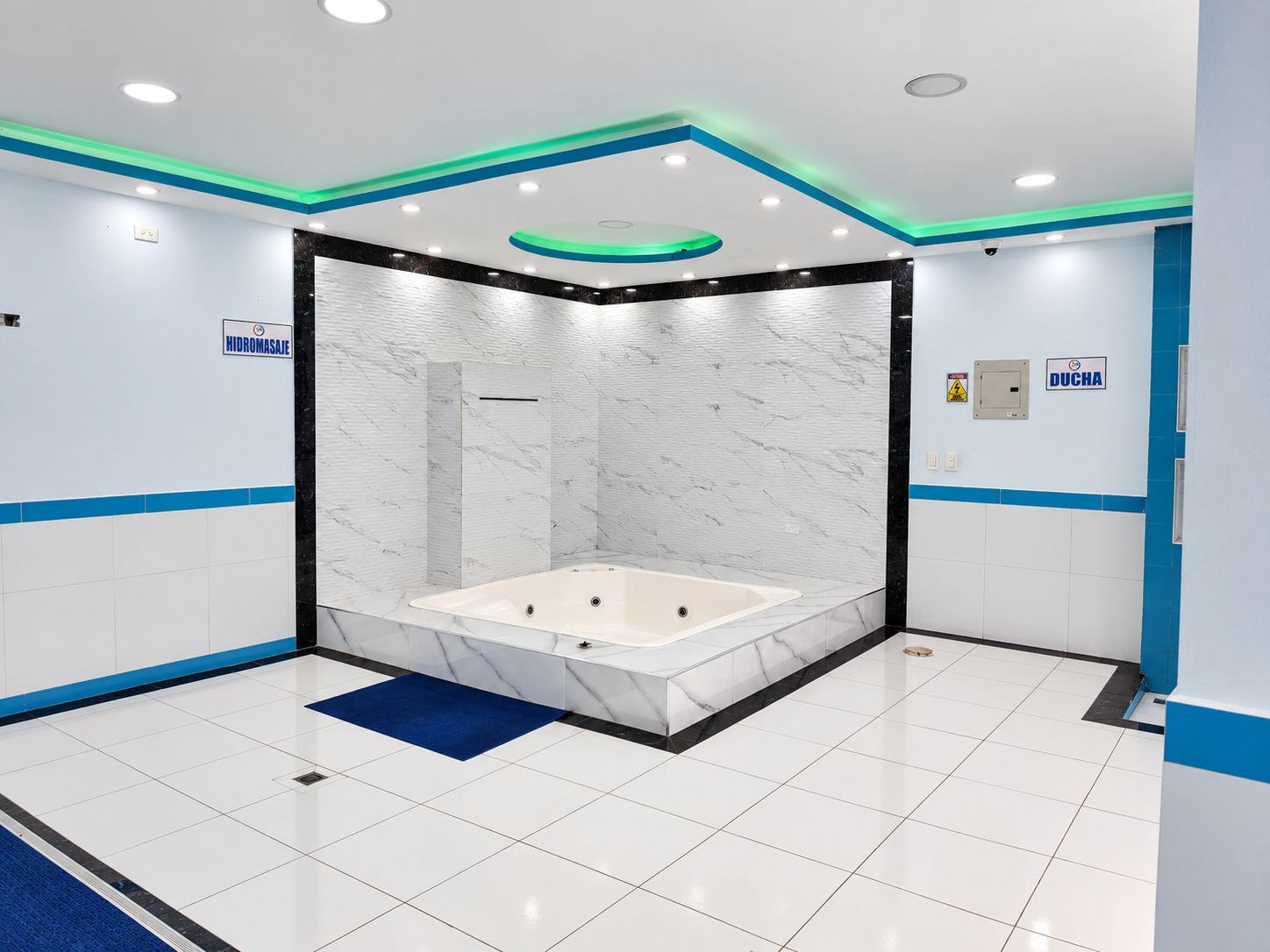 A modern bathroom with a marble vanity, a bathtub, and a shower enclosure.