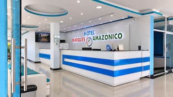 A hotel reception desk with a modern design, featuring a blue and white color scheme and a digital display.