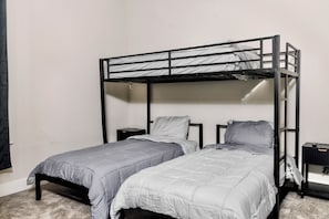 A bunk bed room with two beds, a nightstand, and a desk. - Spacious New 4-bedroom light-house in perfect Dallas with Resort style living. (Dallas)