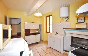 A compact kitchen with a sink, cabinets, and a water heater. - Cozy home in Feuilla with WiFi (Feuilla)