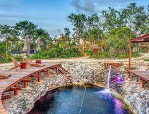 A natural hot spring with wooden walkways and lounge chairs. - Luxury 2BR Penthouse in the Jungle. Nature, Pools & Cenotes in Tulum (Tulum)