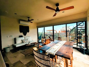 A spacious dining area with a large wooden table, multiple chairs, and a ceiling fan. - Luxury 2BR Penthouse in the Jungle. Nature, Pools & Cenotes in Tulum (Tulum)