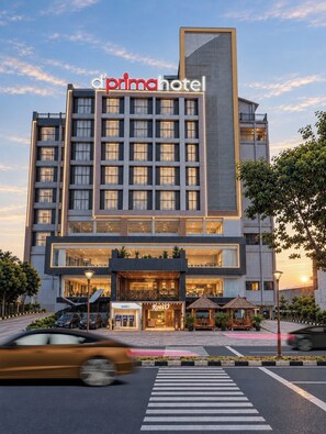 A modern hotel building with a prominent 'd'aria hotel' sign.