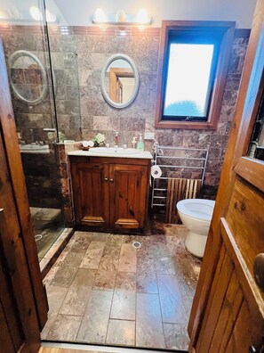 A bathroom with a wooden vanity, a glass shower enclosure, and a window. - 5-bedroom vineyard cottage for groups McLaren Vale (Blewitt Springs)