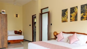 A hotel room with a large bed, a smaller bed, a wardrobe, and a door leading to another room. - Mashmellow Resort & Spa (Galle)