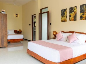 A hotel room with a large bed, a smaller bed, a wardrobe, and a door leading to another room. - Mashmellow Resort & Spa (Galle)