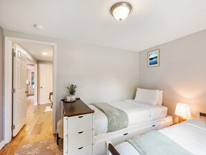 A bedroom with a bed, bedside table, lamp, and a picture on the wall. - Charm and Cozy! (Toccoa)