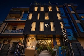 A hotel entrance with a sign for 'HOTEL PRIYAD & RESTRO' and a sign indicating 'ROOF TUBE RESTRO CAFE SANQUETE'. - Hotel Priyaj  (Jaipur)