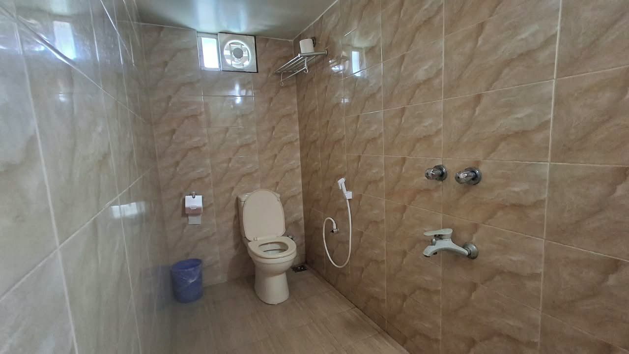 Un baño con inodoro, ducha y lavamanos.