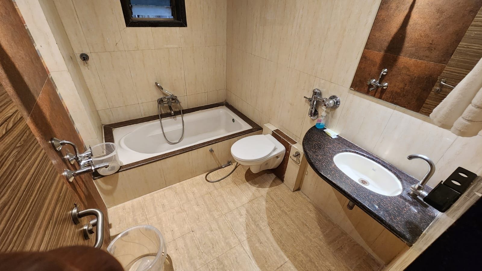 A bathroom with a bathtub, toilet, and sink.