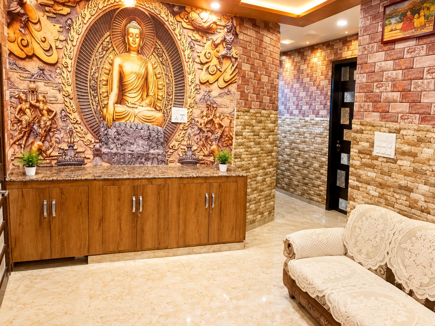 Una zona de recepción con una estatua de Buda, armarios de madera y una pared de ladrillo.