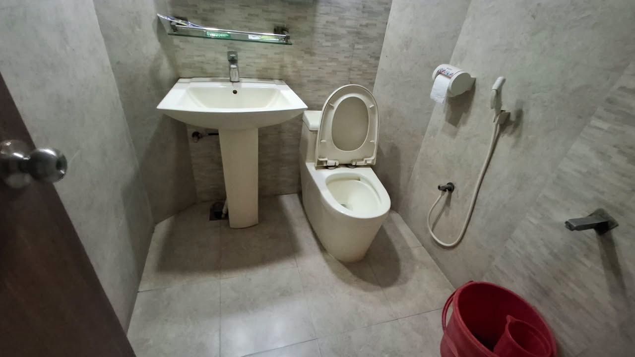 A bathroom with a sink, toilet, and shower.