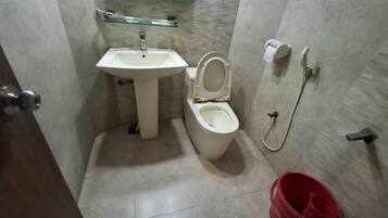 A bathroom with a sink, toilet, and shower.