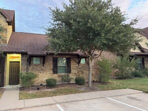 A residential building with a stone facade, a brown door, and a tree in the front yard. - 3 Bedrooms - 3 Bathrooms, 7 min to Texas A&M (College Station)