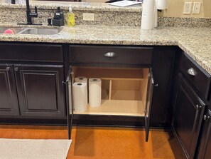 A kitchen with a granite countertop, a black sink, and a hidden storage cabinet with toilet paper. - 3 Bedrooms - 3 Bathrooms, 7 min to Texas A&M (College Station)
