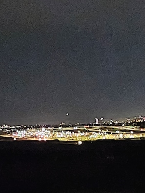A nighttime cityscape with a view of buildings and lights.