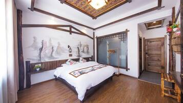 A bedroom with a wooden bed, a decorative wall, and a traditional ceiling design.