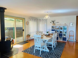 A dining area with a white table, chairs, and a patterned rug. - My Time @ Robe - Views- Wood fire (Robe)