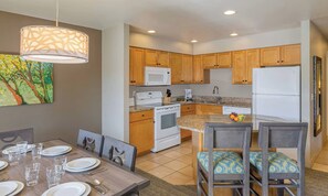 A modern kitchen with wooden cabinets, a microwave, stove, and a refrigerator. - Oktoberfest & Marathon Weekend! 2BR WorldMark Resort (Leavenworth)