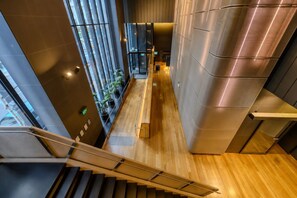 A modern interior with a staircase, wooden flooring, and a view through large windows. - Stay in the Heart of Melbourne CBD-Walk Everywhere (Melbourne)