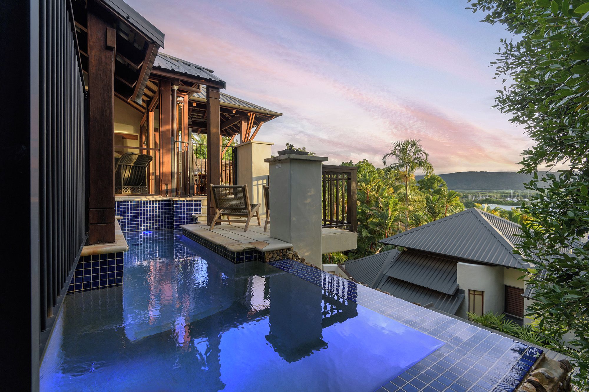 A pool area with a view of a mountainous landscape.