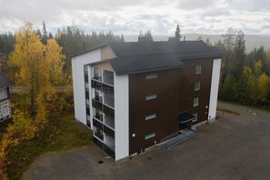 A modern building with a flat roof, multiple windows, and a small entrance area. - Levi South Studio 1, Private Sauna By Lapland Host (Levi)