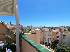 A residential area with buildings, a clear sky, and a green awning. - Villa in Nerja Near Burriana Beach (Nerja)